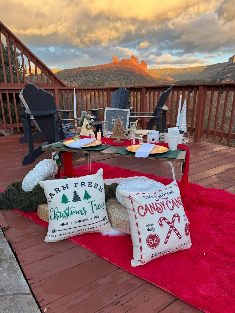 Christmas date-night setup on a Sedona deck with Adirondack chairs and red sky