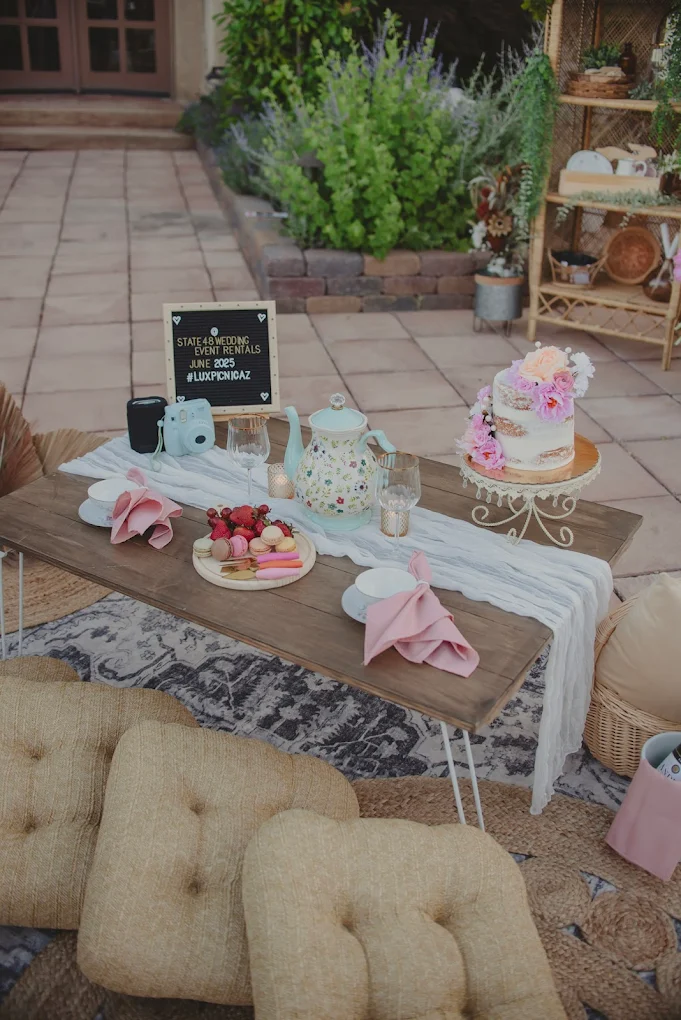 Lux tea party picnic with floral teapot, macarons, Instax camera and floral cake