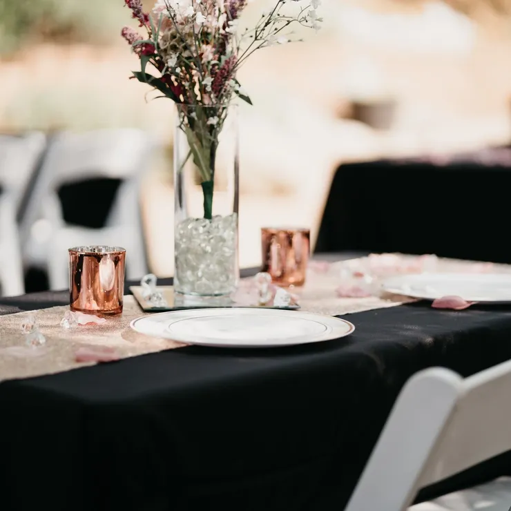 Black linen tablescape with rose gold votives and wildflower centerpiece