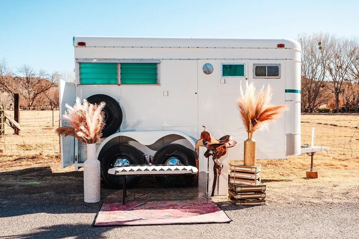 Styled vintage horse trailer with pampas grass and Western decor for an outdoor event